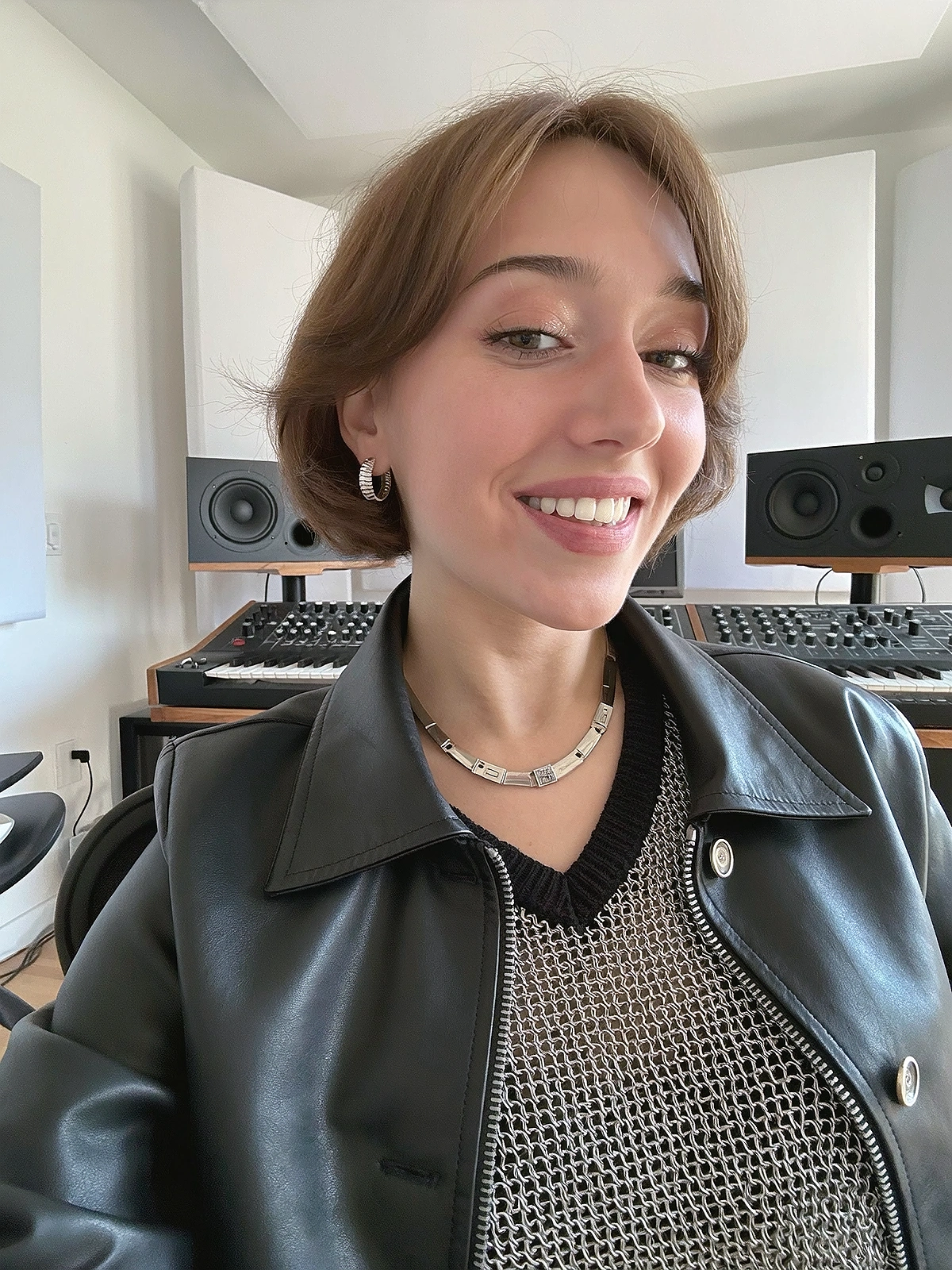 Close shoulder-up candid portrait of a fictional dance-pop / disco singer in her own music recording studio