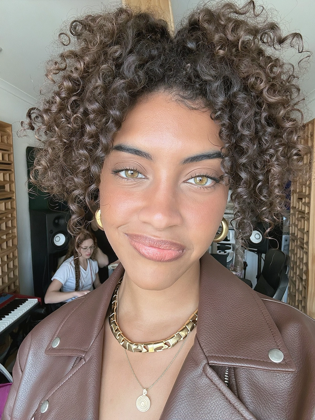 Close shoulder-up candid portrait of a fictional pop / afro-r&b singer in her own music recording studio