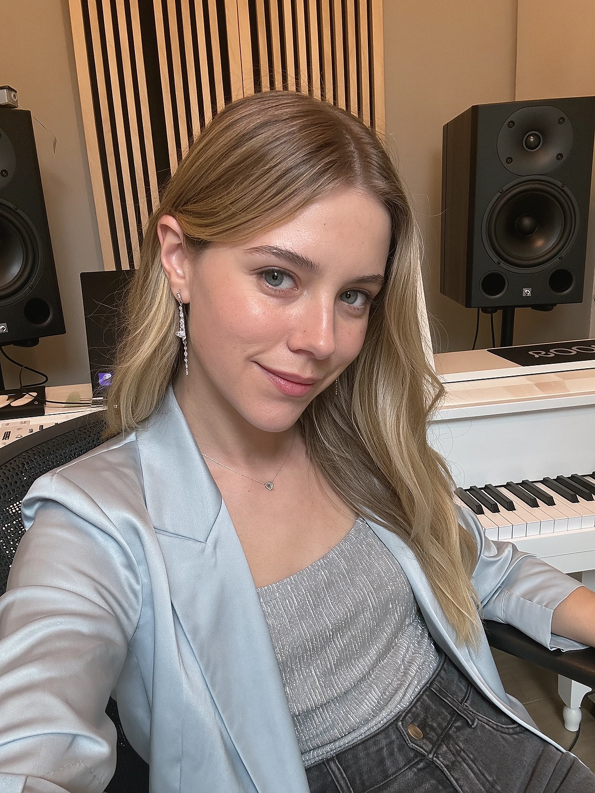 Close shoulder-up candid portrait of a fictional pop / dance singer in her own music recording studio