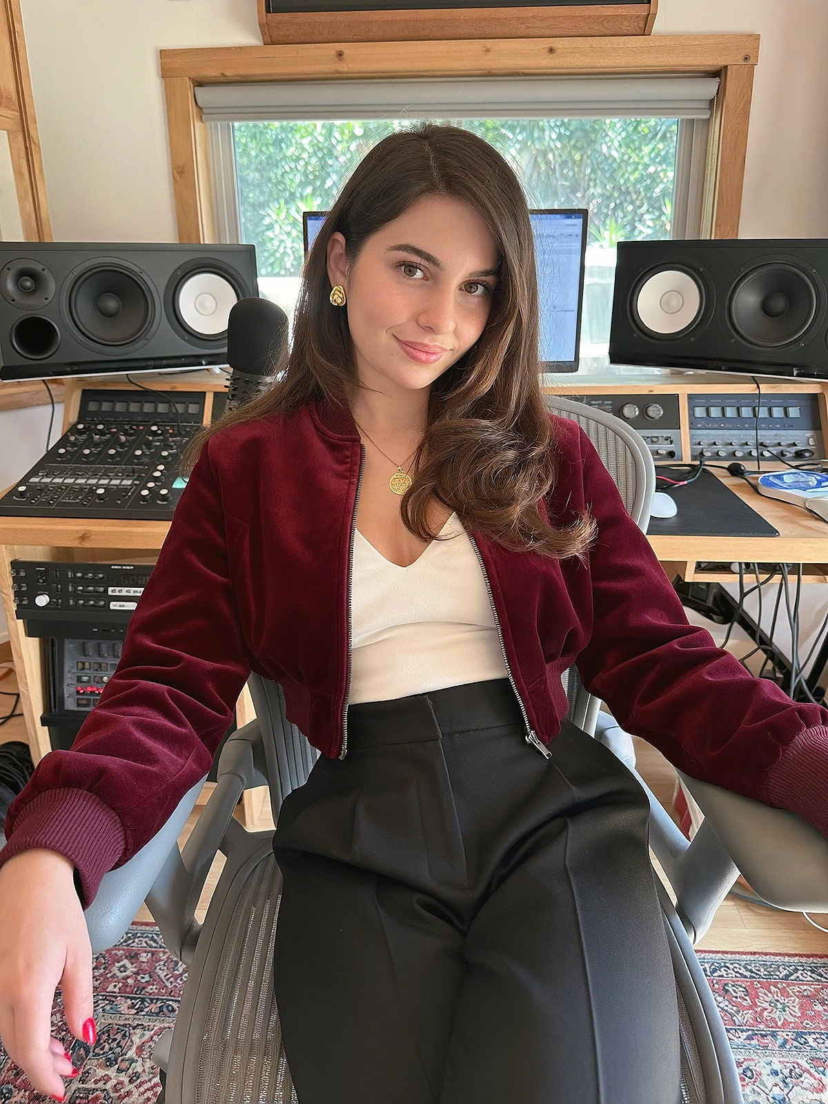 Close shoulder-up candid portrait of a fictional pop / soul singer in her own music recording studio