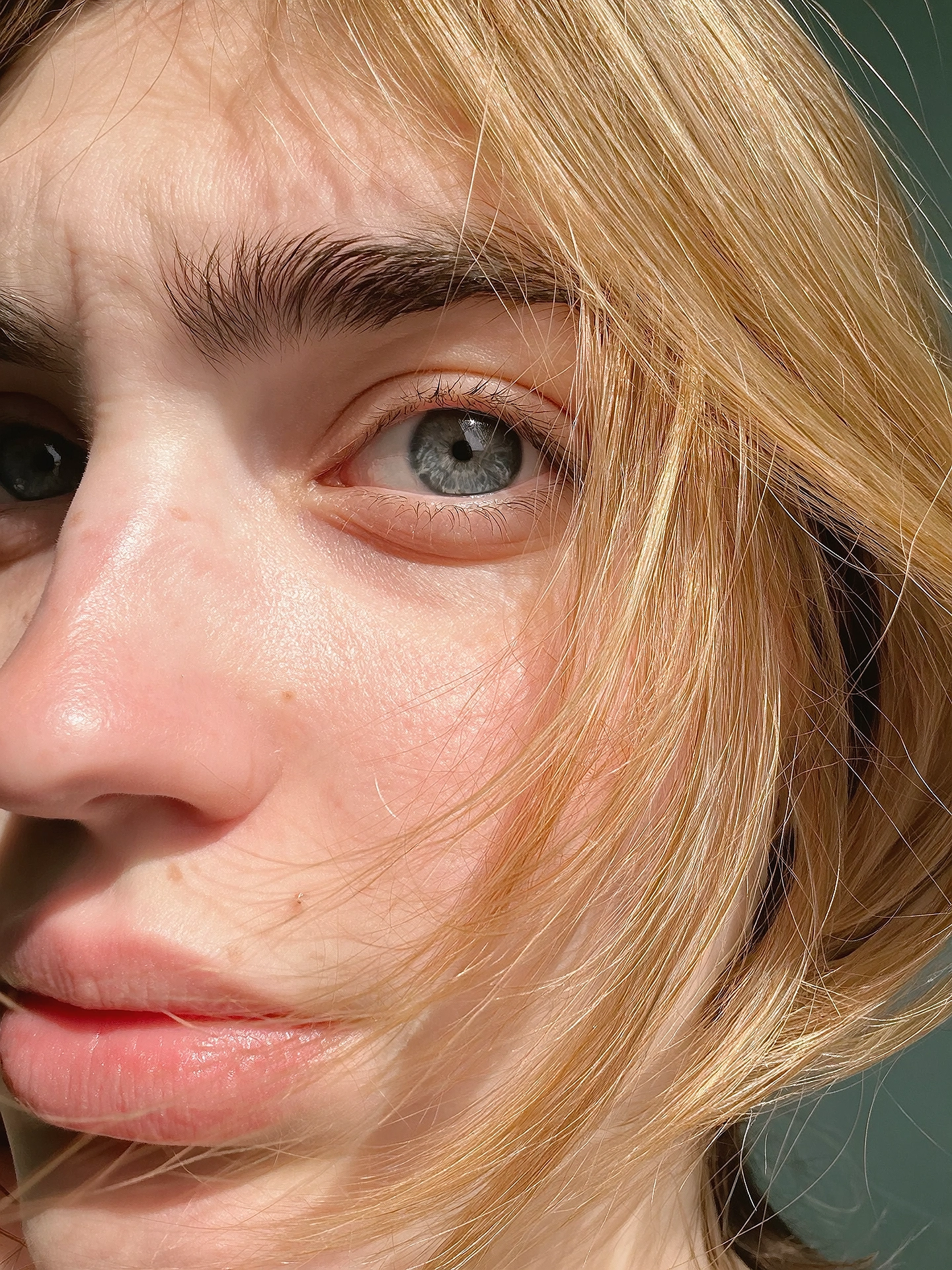 Blonde portrait close-up showing eye detail, expression and natural skin